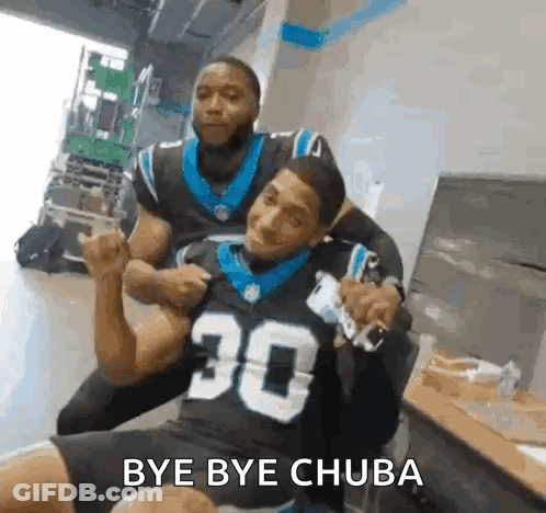 Man In Carolina Panthers Jersey Sitting With Another Man GIF