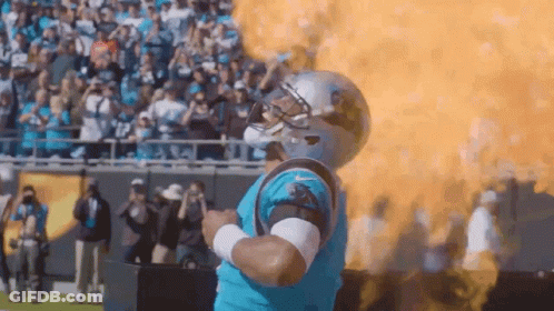 Man In Carolina Panthers Uniform In Front Of Fireball GIF