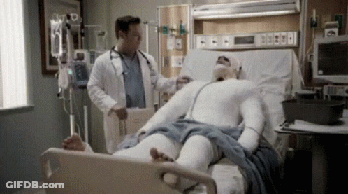 Man In Cast Laying In Hospital Bed With Doctor GIF