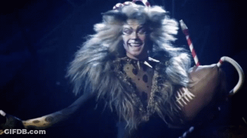 Man In Cat Costume Holding Cane Smiling GIF