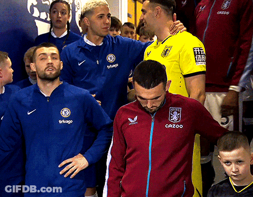 Man In Cazoo Jacket Next To Man In Yellow Shirt GIF
