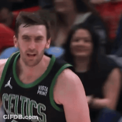 Man In Celtics Jersey Stands In Front Of Seated Woman GIF