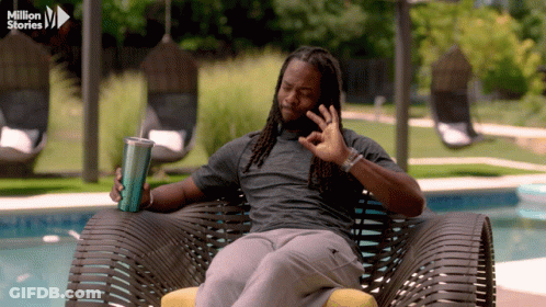 Man In Chair Holding Cup Saying Million Stories GIF