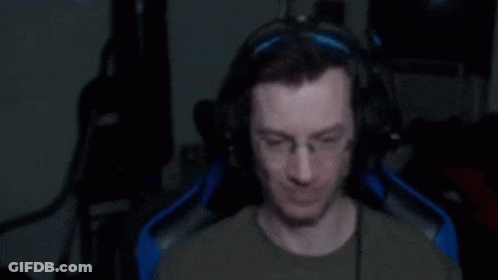Man In Chair Shouting With Fist In Air GIF