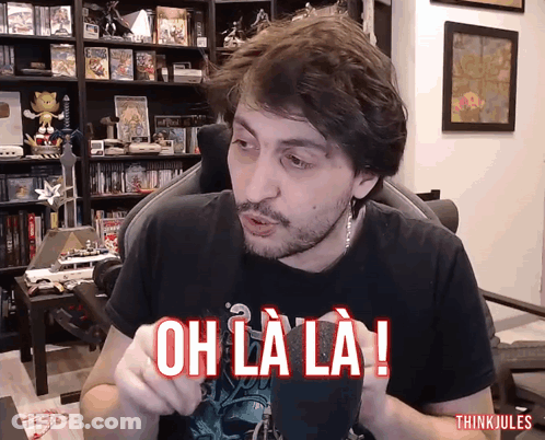Man In Chair With Oh La La Shirt GIF
