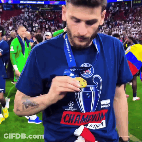 Man In Champions League T-Shirt Holding Medal GIF
