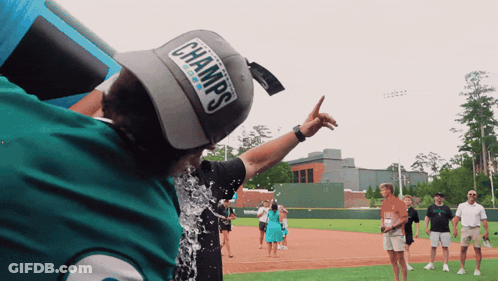 Man In Champs Hat Being Poured With Water GIF
