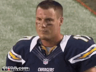Man In Chargers Jersey Sitting On Field GIF