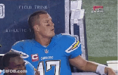 Man In Chargers Jersey Talking To Man In Helmet GIF