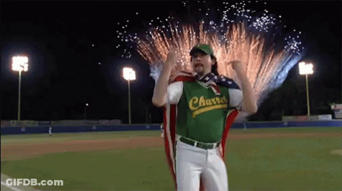 Man In Charro Jersey Standing Before Fireworks GIF
