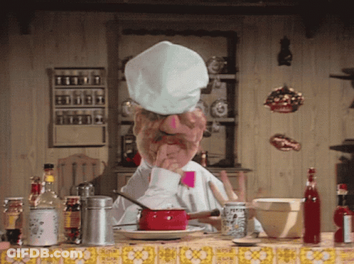 Man In Chef Hat Sitting At Kitchen Table GIF