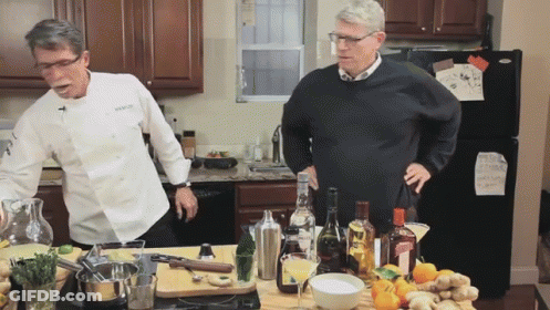 Man In Chef Jacket Next To Man In Sweater GIF