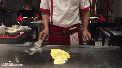 Man In Chef's Uniform Cooking On Stove GIF