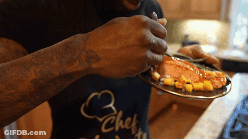 Man In Chef Shirt Eating Food GIF