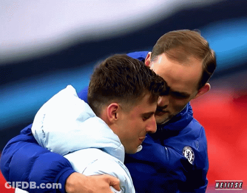 Man In Chelsea Jacket Hugging Man In Blue Jacket GIF