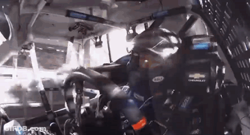 Man In Chevrolet Helmet Driving Race Car GIF