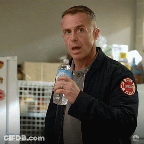 Man In Chicago Fire Department Jacket Holding Water Bottle GIF