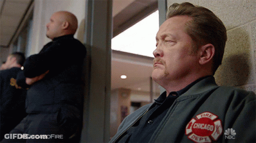 Man In Chicago Fire Department Jacket Looking Out Window GIF