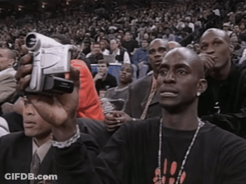 Man In Chicago Shirt Holding Video Camera GIF
