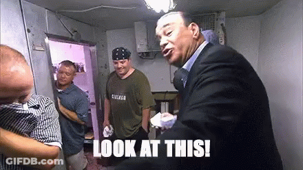 Man In Chicago Shirt Standing Next To Another Man GIF