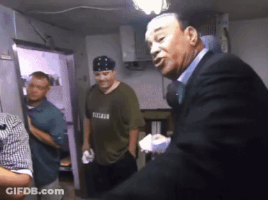 Man In Chicago Shirt Talking To Man In Suit GIF
