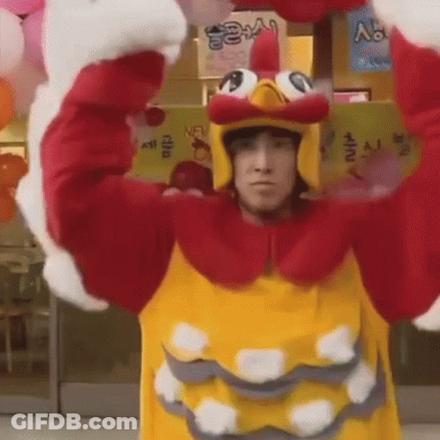 Man In Chicken Costume Holding Balloons In Front Of Store GIF