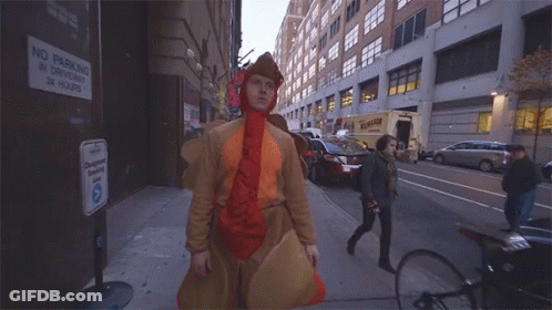 Man In Chicken Costume Saying Yoohoo On Street GIF