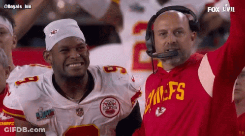 Man In Chiefs Jersey Next To Man With White Headband GIF