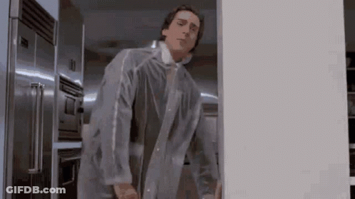 Man In Clear Plastic Coat Standing In Front Of Refrigerator GIF