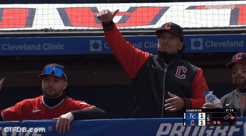Man In Cleveland Clinic Jacket In Dugout GIF