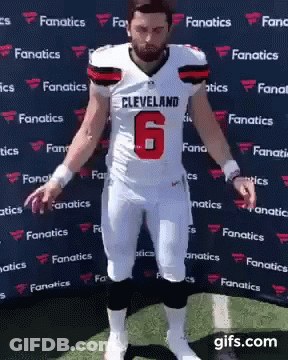 Man In Cleveland Football Uniform Standing On Field GIF