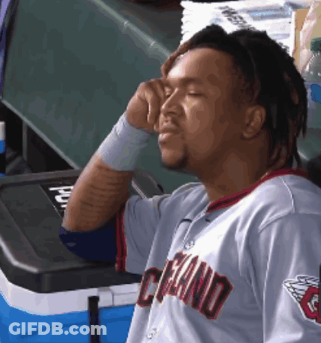 Man In Cleveland Jersey Sitting By Cooler GIF