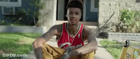 Man In Cleveland Jersey Sitting On Sidewalk GIF