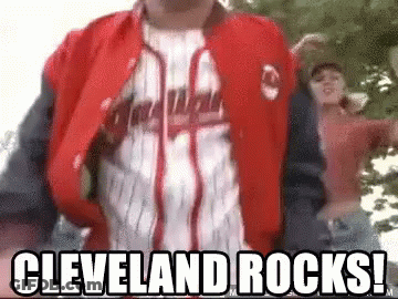 Man In Cleveland Rocks Jacket Next To Woman In Pink GIF