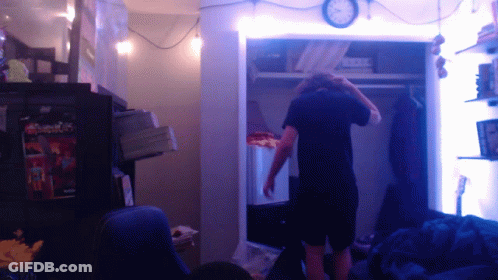 Man In Closet With Clock GIF