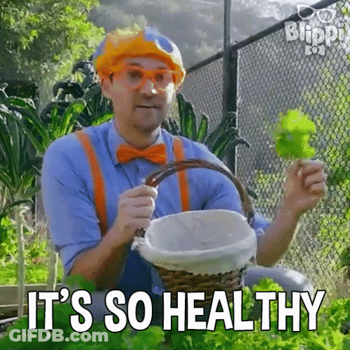 Man In Clown Costume Holding Basket Of Lettuce GIF