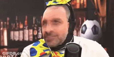 Man In Clown Costume Holding Microphone GIF