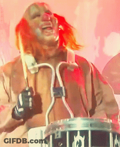 Man In Clown Costume Playing Drum Set GIF