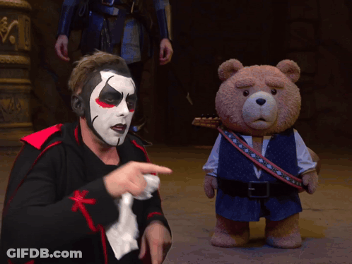 Man In Clown Costume Pointing At Teddy Bear GIF