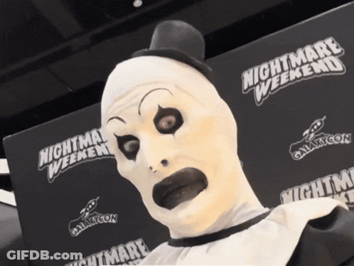 Man In Clown Costume Touched By Santa GIF