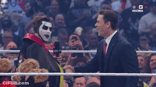 Man In Clown Mask Shaking Hands With Suit GIF