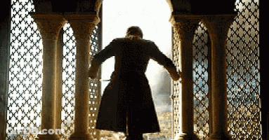 Man In Coat Looking Out Window GIF