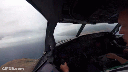 Man In Cockpit Looking Out Window GIF