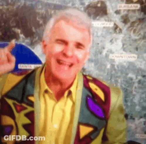 Man In Colorful Jacket Smiling In Front Of Downtown Map GIF