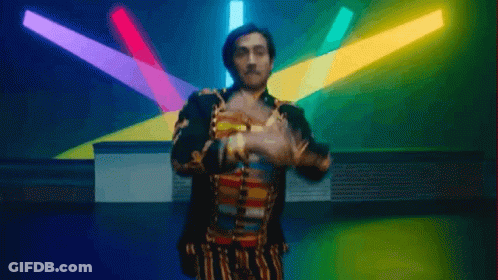 Man In Colorful Outfit Dancing In Front Of Lights GIF