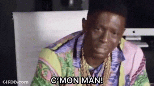 Man In Colorful Shirt And Gold Chains Sitting At Computer Says C Mon Man GIF
