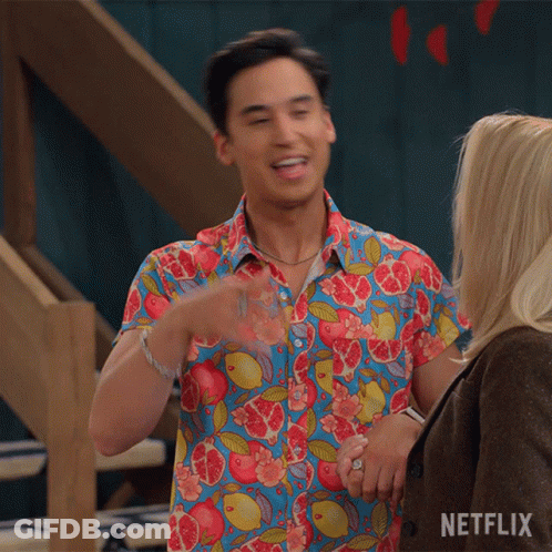 Man In Colorful Shirt Next To Woman With Netflix Logo GIF