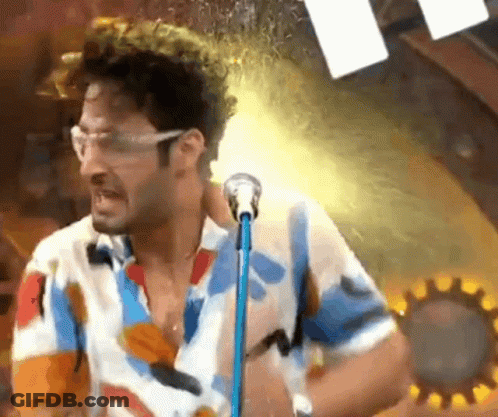 Man In Colorful Shirt Singing Into Microphone GIF