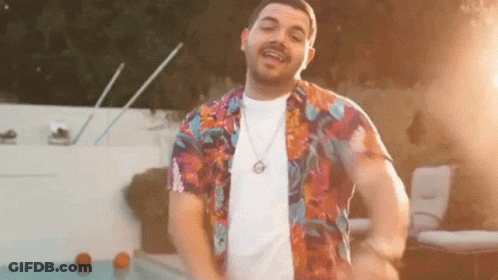 Man In Colorful Shirt Standing In Front Of Pool GIF
