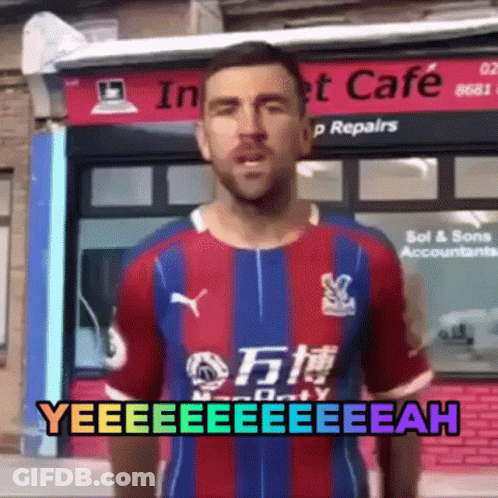 Man In Colorful Shirt Standing In Front Of Store GIF